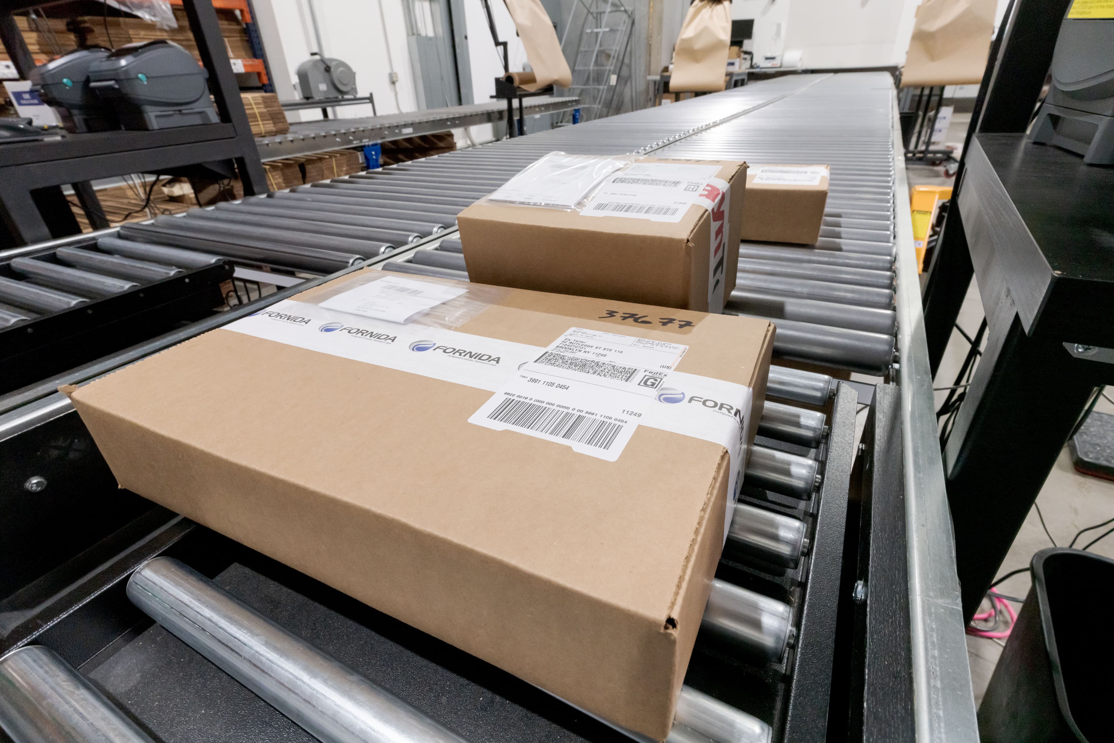 Fornida-branded packed boxes moving down the dispatch conveyor