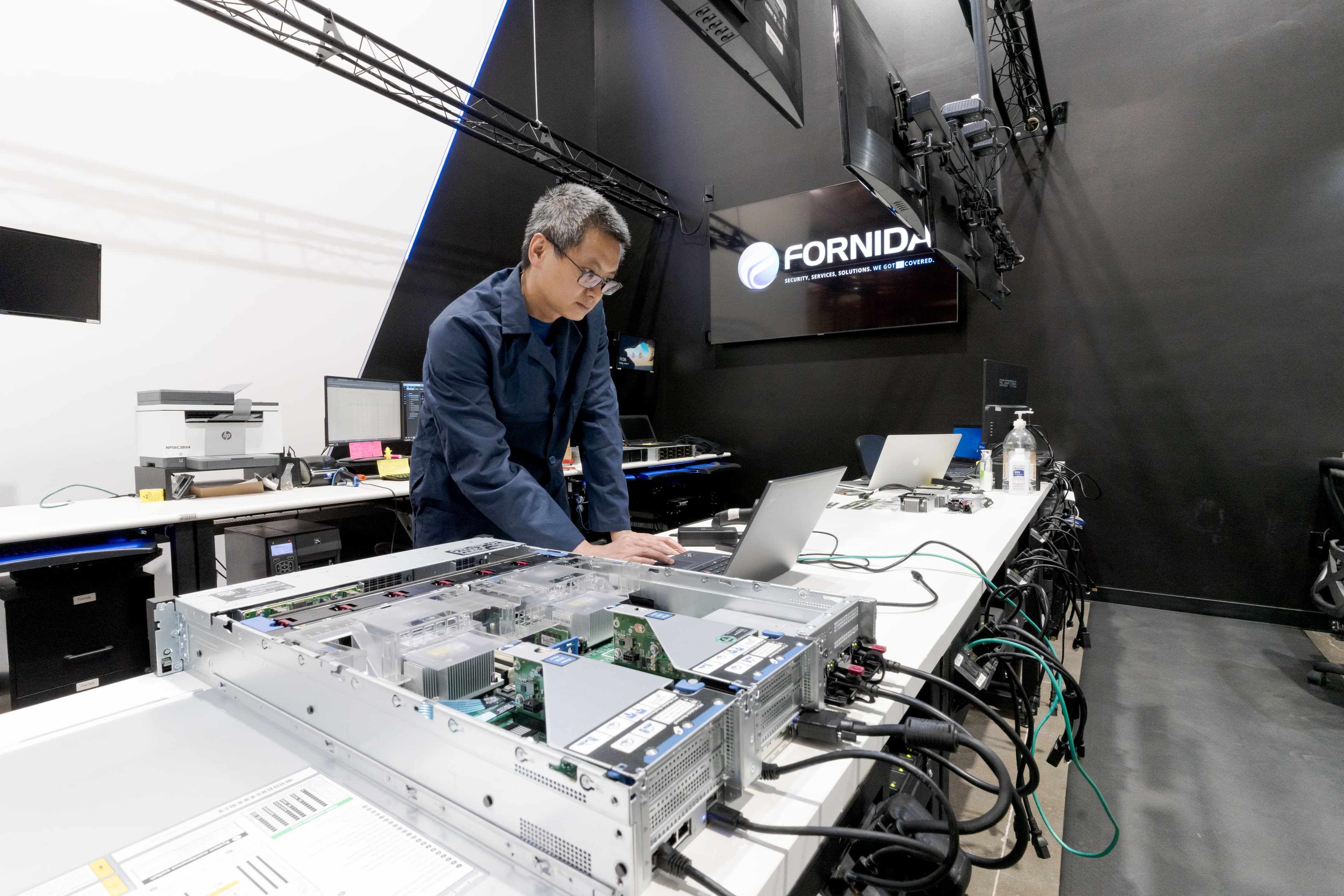 Fornida engineer working on an open rack server at the hardware lab bench