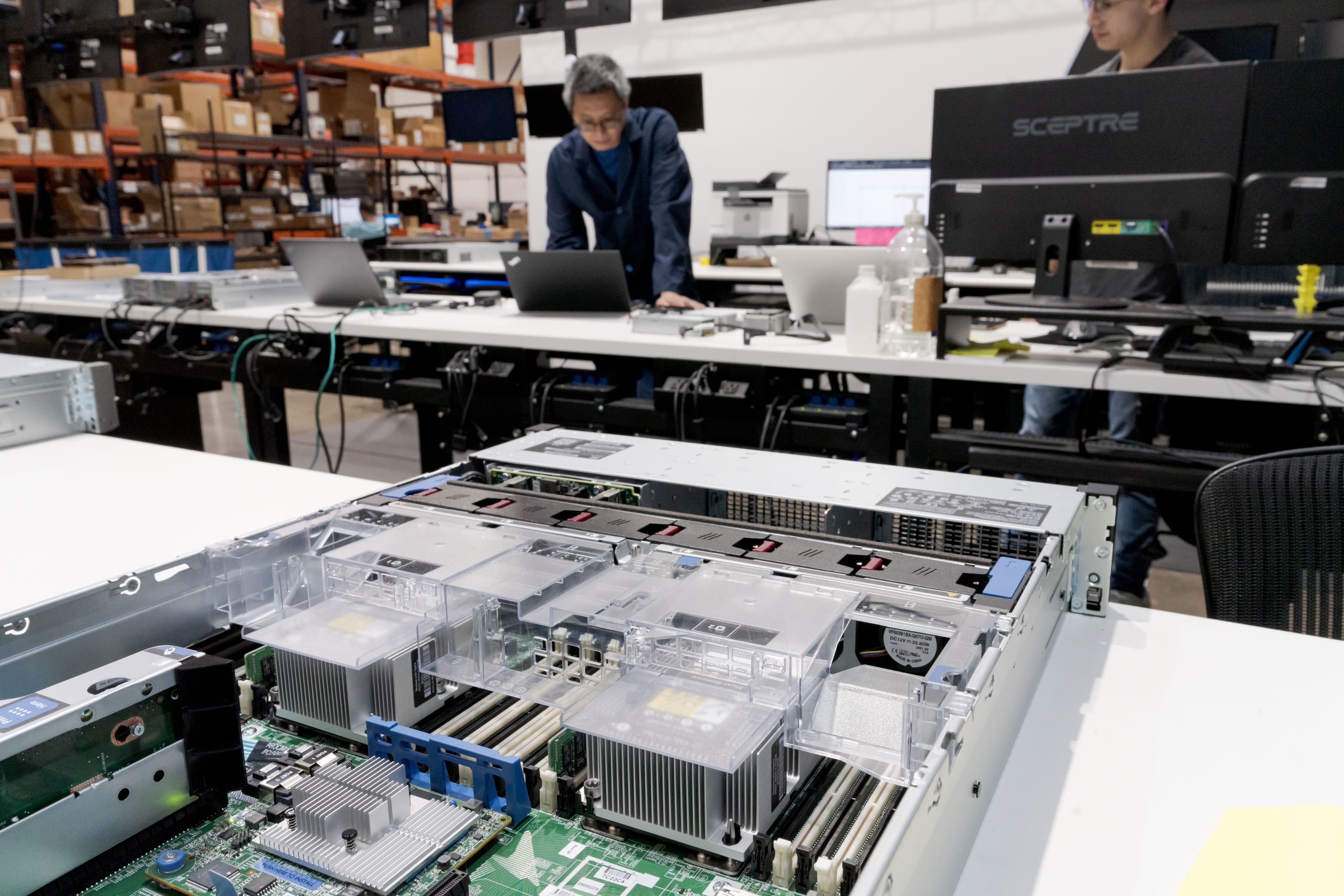 Close-up of an open server motherboard, CPU heatsinks, and DIMM slots on the Fornida bench